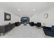 Elegant living room with a fireplace, marble floors, recessed lighting, and modern furniture at 1413 E 108Th Ave, Tampa, FL 33612