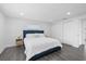 Spacious bedroom featuring a plush bed, gray laminate flooring, closet, and plenty of natural light at 1413 E 108Th Ave, Tampa, FL 33612