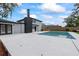 Rear exterior view showing the pool, patio, and dark chimney at 1413 E 108Th Ave, Tampa, FL 33612