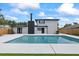 Backyard features a pool, well manicured lawn, and updated home exterior at 1413 E 108Th Ave, Tampa, FL 33612