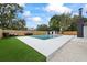 Backyard features a swimming pool, patio furniture, and fenced yard at 1413 E 108Th Ave, Tampa, FL 33612