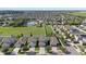Panoramic aerial view of the community showcasing the pool and nearby residential area at 14403 Dunrobin Dr, Wimauma, FL 33598