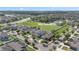 Aerial view of home at 14403 Dunrobin Dr with neighborhood, landscaping, and community pool nearby at 14403 Dunrobin Dr, Wimauma, FL 33598