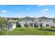 Aerial view of the backyard, highlighting the lawn and privacy between neighboring homes at 14403 Dunrobin Dr, Wimauma, FL 33598