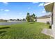 Spacious backyard featuring lush grass and white vinyl fencing, perfect for outdoor activities at 14403 Dunrobin Dr, Wimauma, FL 33598