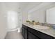 Well-lit bathroom featuring a shower and vanity with black cabinets at 14403 Dunrobin Dr, Wimauma, FL 33598