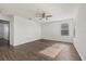 Bright bedroom features wood-look floors and a ceiling fan at 14403 Dunrobin Dr, Wimauma, FL 33598