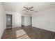 Spacious bedroom features wood-look floors and ceiling fan at 14403 Dunrobin Dr, Wimauma, FL 33598