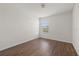 Bedroom featuring wood-look floors and a window at 14403 Dunrobin Dr, Wimauma, FL 33598