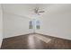 Bright bedroom features wood-look floors and two windows at 14403 Dunrobin Dr, Wimauma, FL 33598