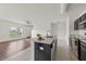 Open concept kitchen featuring a center island with sink and stainless steel appliances at 14403 Dunrobin Dr, Wimauma, FL 33598