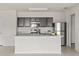 Bright kitchen featuring modern appliances, white countertops, and dark wood cabinetry at 14403 Dunrobin Dr, Wimauma, FL 33598