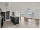 Open-concept kitchen with tile floors and adjacent living area with hardwood flooring and natural light at 14403 Dunrobin Dr, Wimauma, FL 33598