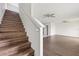 Wooden staircase leading to the upper level of the home, with natural light at 14403 Dunrobin Dr, Wimauma, FL 33598