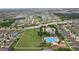 Community aerial view showcasing a pool, playground, lakes, and many homes in a well-planned neighborhood at 14460 English Lavender Dr, Wimauma, FL 33598