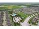 An aerial view of the community, showcasing a pool, tennis court, clubhouse, and neatly arranged homes at 14460 English Lavender Dr, Wimauma, FL 33598