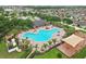 Aerial view of the community featuring a large pool, playground, community center, and lush landscaping at 14460 English Lavender Dr, Wimauma, FL 33598