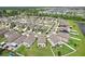 Aerial view of a well-maintained neighborhood with neatly arranged homes, green lawns, and ponds at 14460 English Lavender Dr, Wimauma, FL 33598