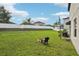 Large backyard with a firepit and chair provides ample space for outdoor activities and relaxation at 14460 English Lavender Dr, Wimauma, FL 33598
