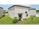 The backyard has sliding glass doors, space for grilling, and a basketball hoop for outdoor activities at 14460 English Lavender Dr, Wimauma, FL 33598