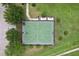 Top-down aerial of a well-maintained, fenced basketball court surrounded by greenery and pedestrian paths at 14460 English Lavender Dr, Wimauma, FL 33598