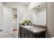 Bathroom with a dark vanity, granite countertops, and a view of laundry room at 14460 English Lavender Dr, Wimauma, FL 33598