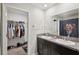 Functional bathroom with a double vanity sink and an open view into a closet at 14460 English Lavender Dr, Wimauma, FL 33598