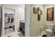 Bright bathroom with a closet to the left, art decorations on the wall, and tiled floors at 14460 English Lavender Dr, Wimauma, FL 33598