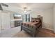 Comfortable bedroom featuring a queen bed, wooden dresser, and a mounted television at 14460 English Lavender Dr, Wimauma, FL 33598