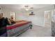 Comfortable bedroom with neutral walls, featuring a cozy bed and a view into the hallway at 14460 English Lavender Dr, Wimauma, FL 33598