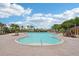 A large community pool surrounded by lounge chairs and lush landscaping, perfect for relaxing and enjoying sunny days at 14460 English Lavender Dr, Wimauma, FL 33598