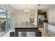 Inviting dining area features a wooden table and chairs with a chandelier at 14460 English Lavender Dr, Wimauma, FL 33598