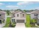 Beautifully landscaped two-story home featuring a two car garage, front lawn, and modern design at 14460 English Lavender Dr, Wimauma, FL 33598