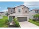 Charming two-story home with a well-maintained lawn and attached two car garage at 14460 English Lavender Dr, Wimauma, FL 33598