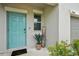 Inviting front entrance with a turquoise door, a 'Welcome' sign, and tasteful landscaping at 14460 English Lavender Dr, Wimauma, FL 33598