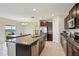 Kitchen with stainless steel appliances, a large island, and a dining area at 14460 English Lavender Dr, Wimauma, FL 33598