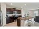 Bright kitchen features stainless steel appliances and a large island at 14460 English Lavender Dr, Wimauma, FL 33598