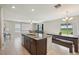 Spacious kitchen and living room area with tile flooring and neutral decor at 14460 English Lavender Dr, Wimauma, FL 33598