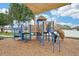 A modern playground with slides, climbing structures, and safety surfacing, offering a fun and secure play area at 14460 English Lavender Dr, Wimauma, FL 33598