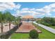 Community playground with swings and sunshade, near lounge area and pool at 14460 English Lavender Dr, Wimauma, FL 33598