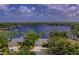 Stunning aerial view of waterfront home with mature trees and direct lake access at 15012 Maurine Cove Ln, Odessa, FL 33556