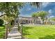 Tranquil backyard with dock access, spacious patio, and well-maintained lawn at 15012 Maurine Cove Ln, Odessa, FL 33556