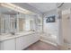 Bathroom with jacuzzi tub, walk in shower, and double sink vanity at 15012 Maurine Cove Ln, Odessa, FL 33556