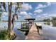 View of the private dock in the backyard, equipped with a boat lift and jet skis at 15012 Maurine Cove Ln, Odessa, FL 33556
