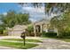 Charming home with landscaped front yard, circular driveway, and welcoming entryway at 15012 Maurine Cove Ln, Odessa, FL 33556