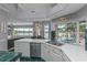 Open kitchen with island, stainless appliances, and views of the water and pool at 15012 Maurine Cove Ln, Odessa, FL 33556