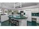 Bright kitchen features island, modern appliances, and an eat-in area with water views at 15012 Maurine Cove Ln, Odessa, FL 33556