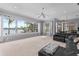 Bright and spacious living room featuring large windows with serene lake views, a comfortable leather sectional, and modern lighting at 15012 Maurine Cove Ln, Odessa, FL 33556