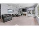 Expansive living room with a cozy fireplace, built-in shelves, and a large window overlooking the serene lake view at 15012 Maurine Cove Ln, Odessa, FL 33556