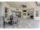 Covered patio featuring a ceiling fan and sliding glass doors overlooking the backyard and lake at 15012 Maurine Cove Ln, Odessa, FL 33556